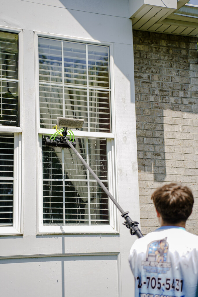 Pure Reflections technician performing exterior window cleaning in South Strabane, PA using a professional water-fed pole system.