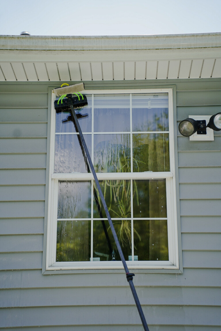 Pure Reflections technician performing exterior window cleaning in Southpointe, PA using a professional water-fed pole system on residential home.