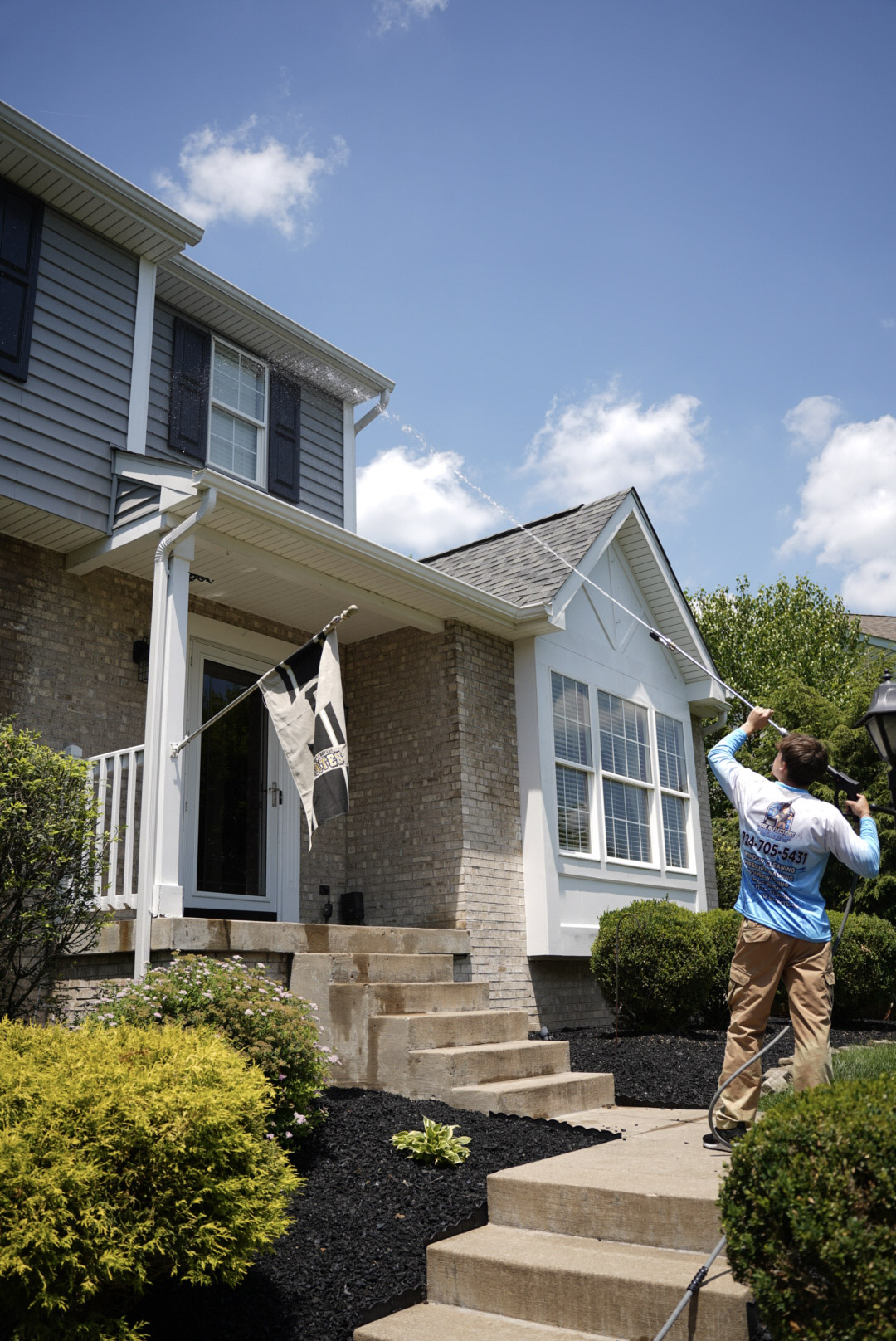 House washing service in Robinson Township PA cleaning second-story siding and trim using a soft wash system.