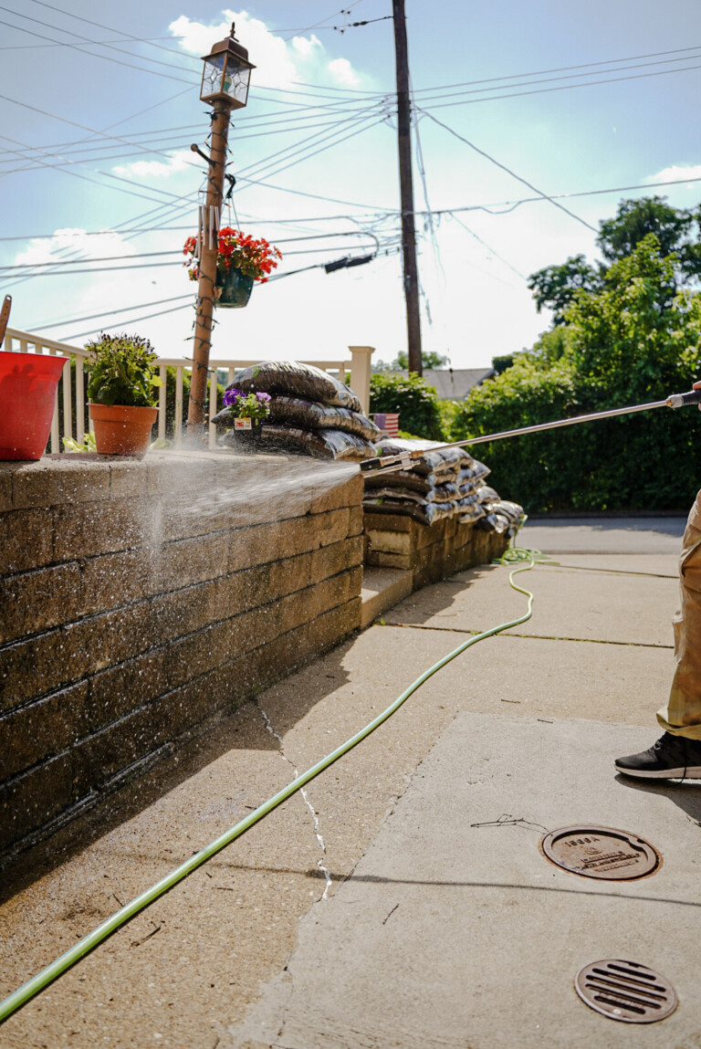 Pure Reflections pressure washing retaining wall and concrete driveway in Bethel Park, PA.